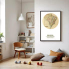 a cozy living room with a wooden chair, a bookshelf filled with books, and a framed map of Brazil hanging on the wall.