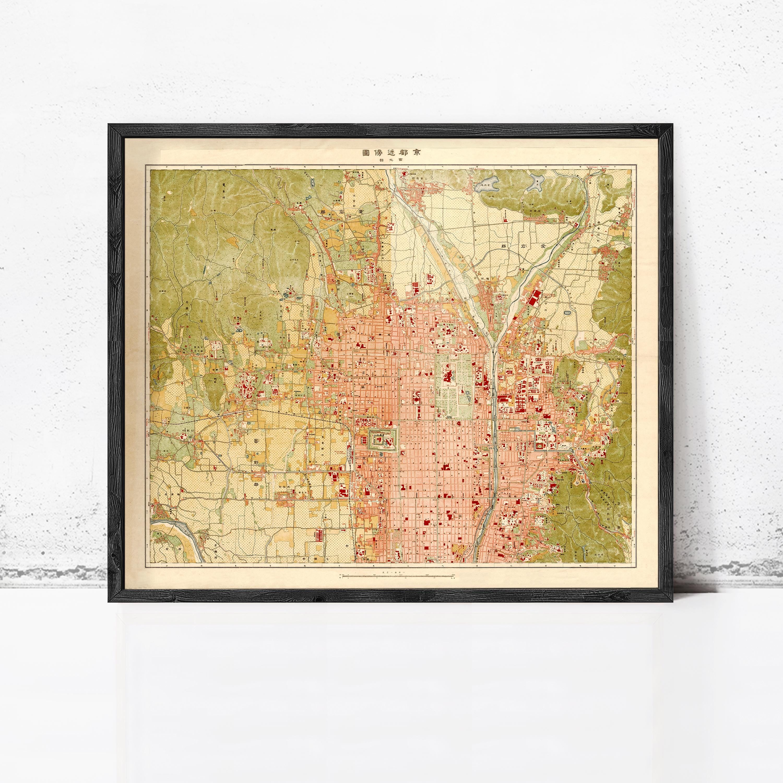 The image is a framed vintage map of a city, likely from the early 20th century, with a color palette of green, red, and yellow.