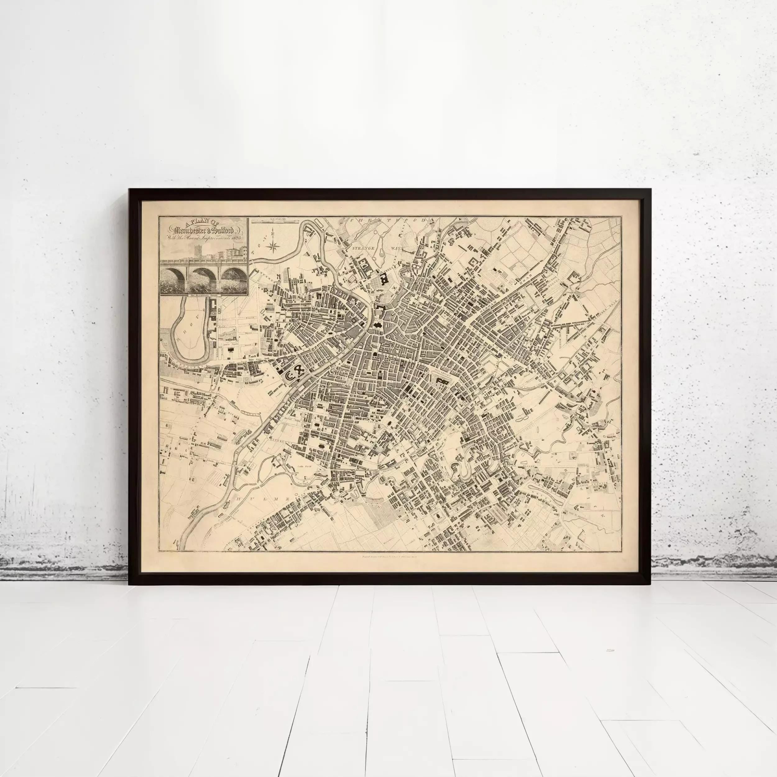 The image is a framed map of a city, likely a historical or geographical map, displayed on a white wall.