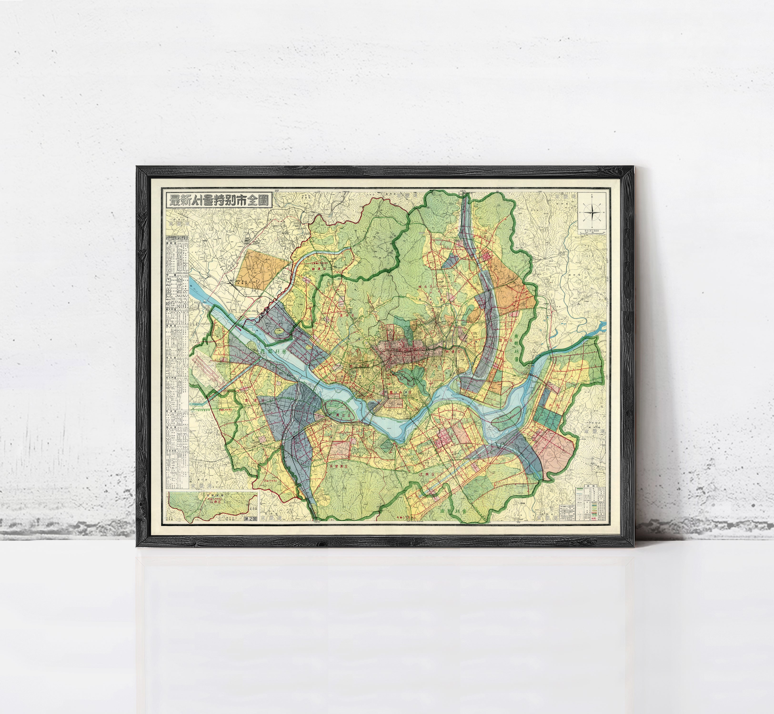 The image is a framed map of a city, showing various streets, landmarks, and geographical features.