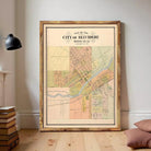 The image is a framed map of the City of Beindere, showing a detailed layout of the city's streets, neighborhoods, and other geographic features.