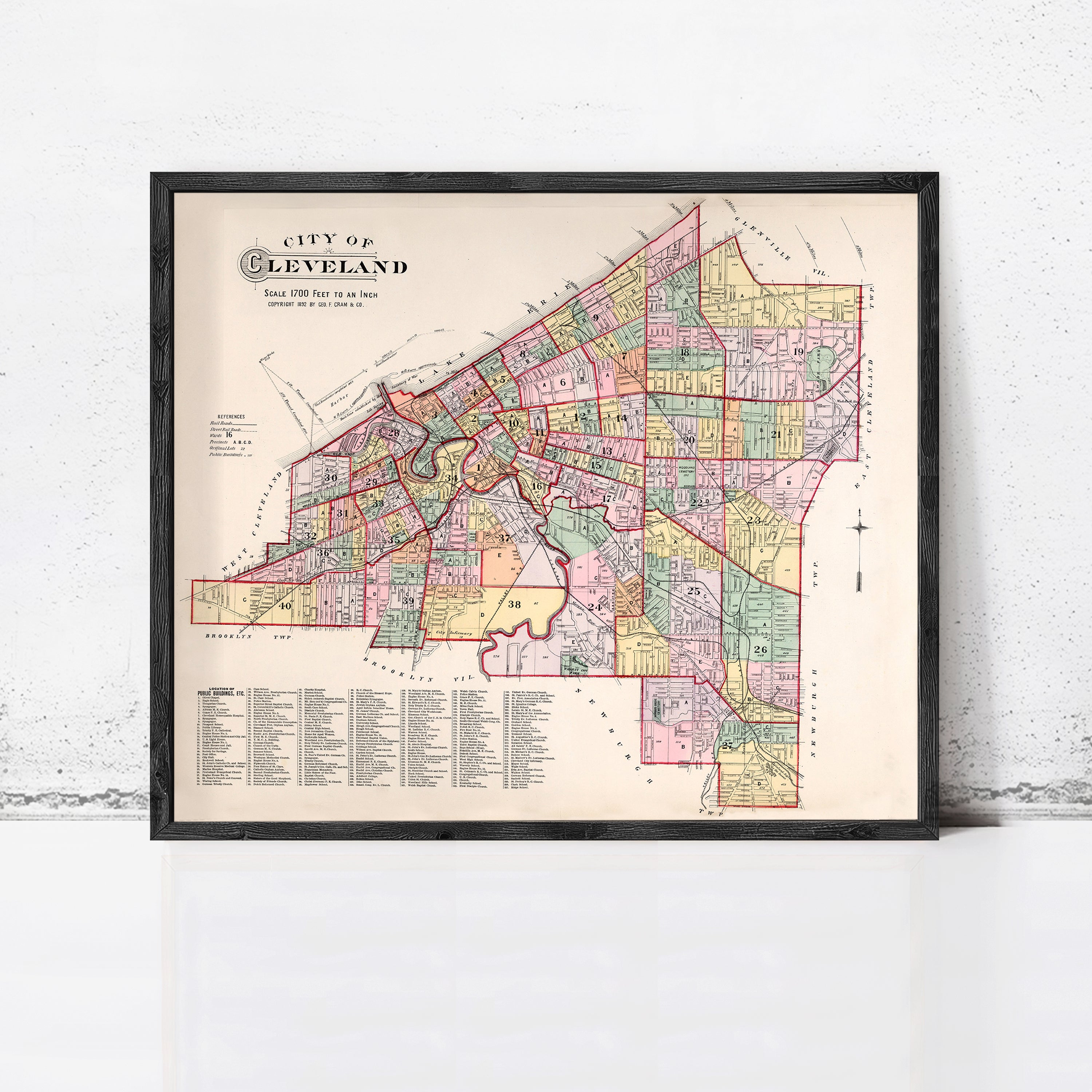 The image is a framed vintage map of Cleveland, Ohio, depicting the city's streets and neighborhoods in a detailed and colorful manner.