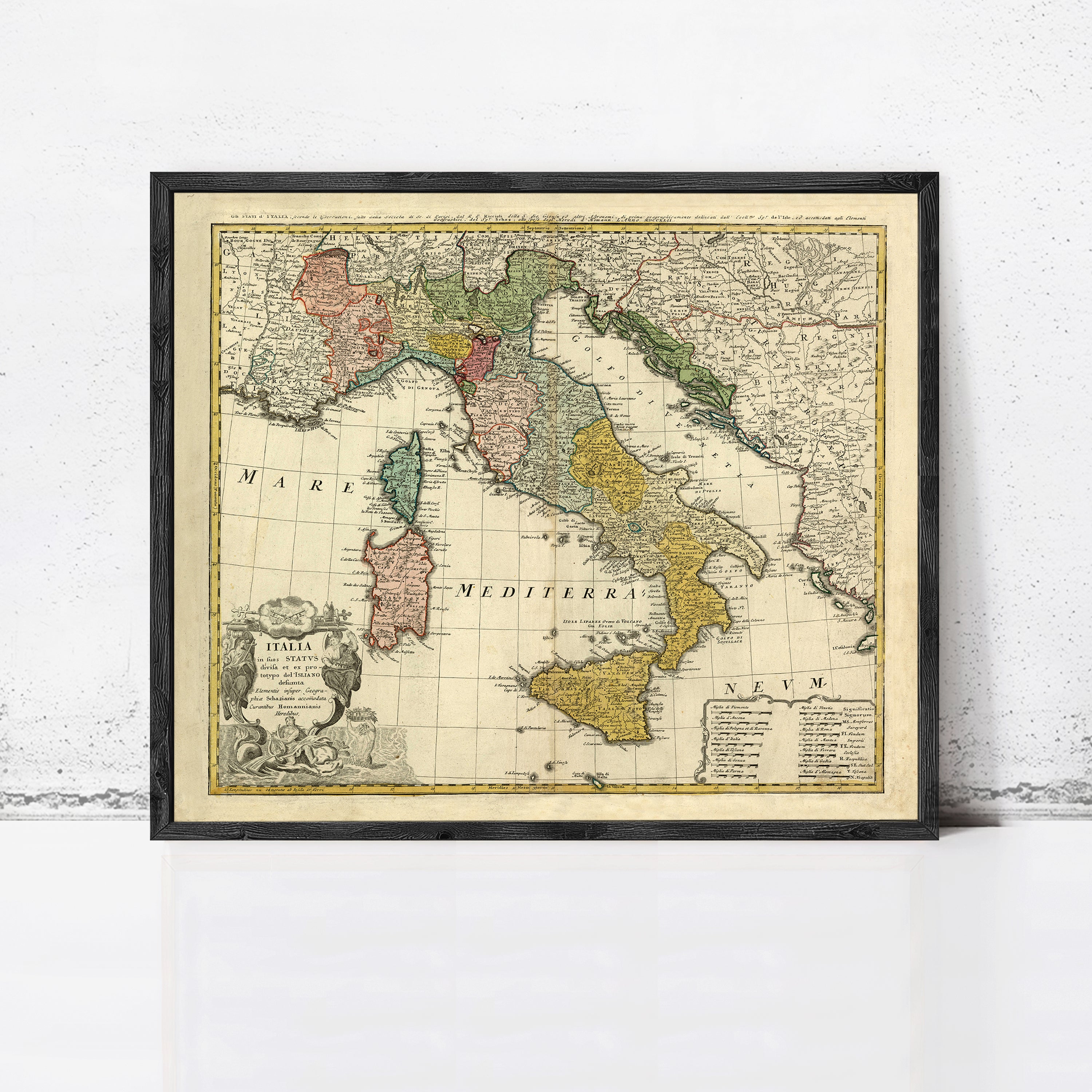 The image is a framed vintage map of Italy, showing the country's geographical layout and surrounding regions.
