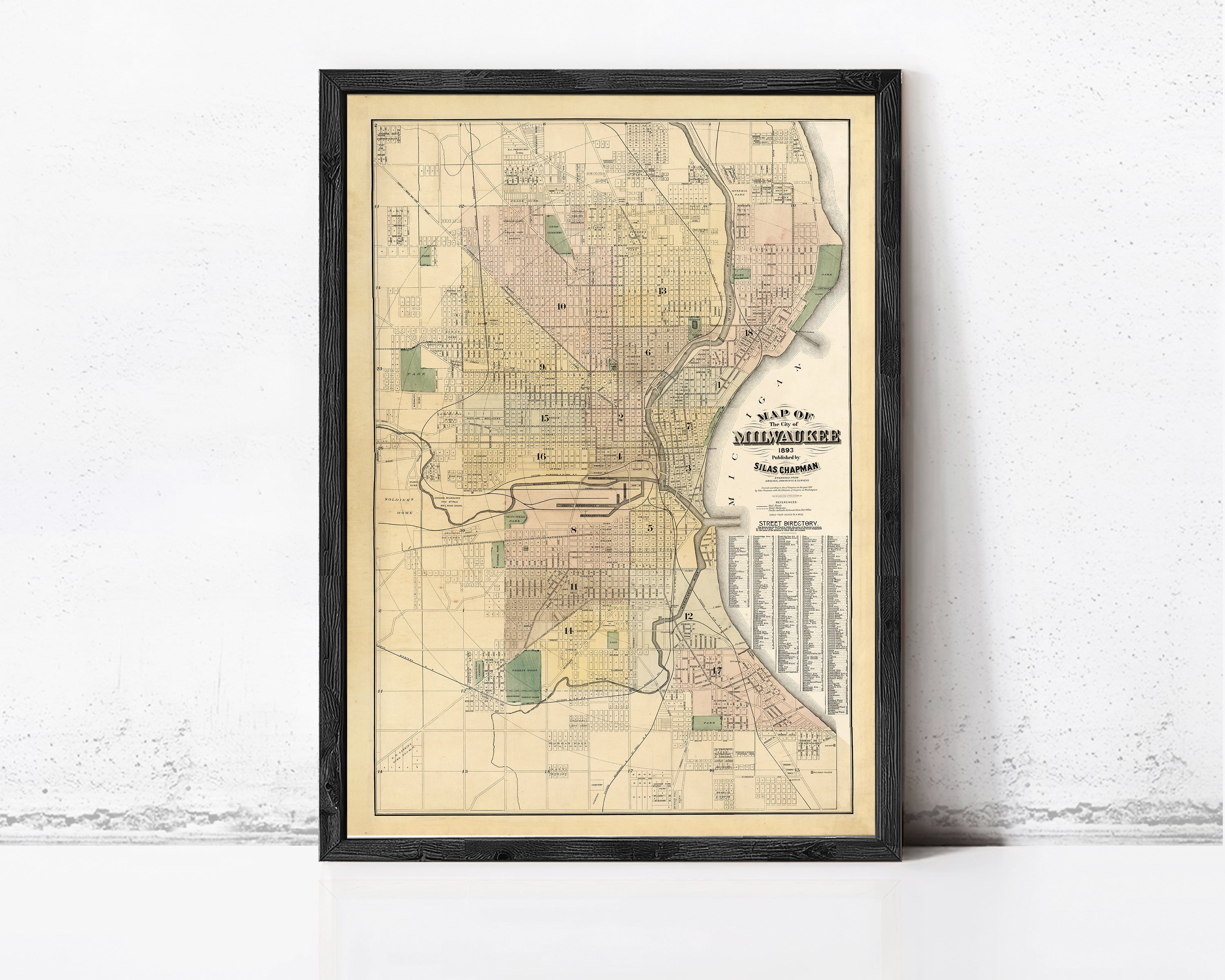 The image is a framed map of Milwaukee, Wisconsin, depicting the city's streets and neighborhoods.
