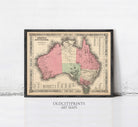 The image is a framed vintage map of Australia, with a black border and a beige background.