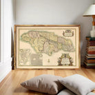 The image is a framed vintage map of Jamaica, featuring detailed geographical information and a decorative border.