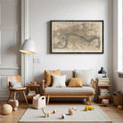 A cozy living room with a large framed map of London hanging on the wall, a wooden sofa with throw pillows, a wooden chair, a lamp, and a small teddy bear.