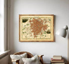 The image is a framed map of a city, likely a historical or vintage map, displayed on a wall.