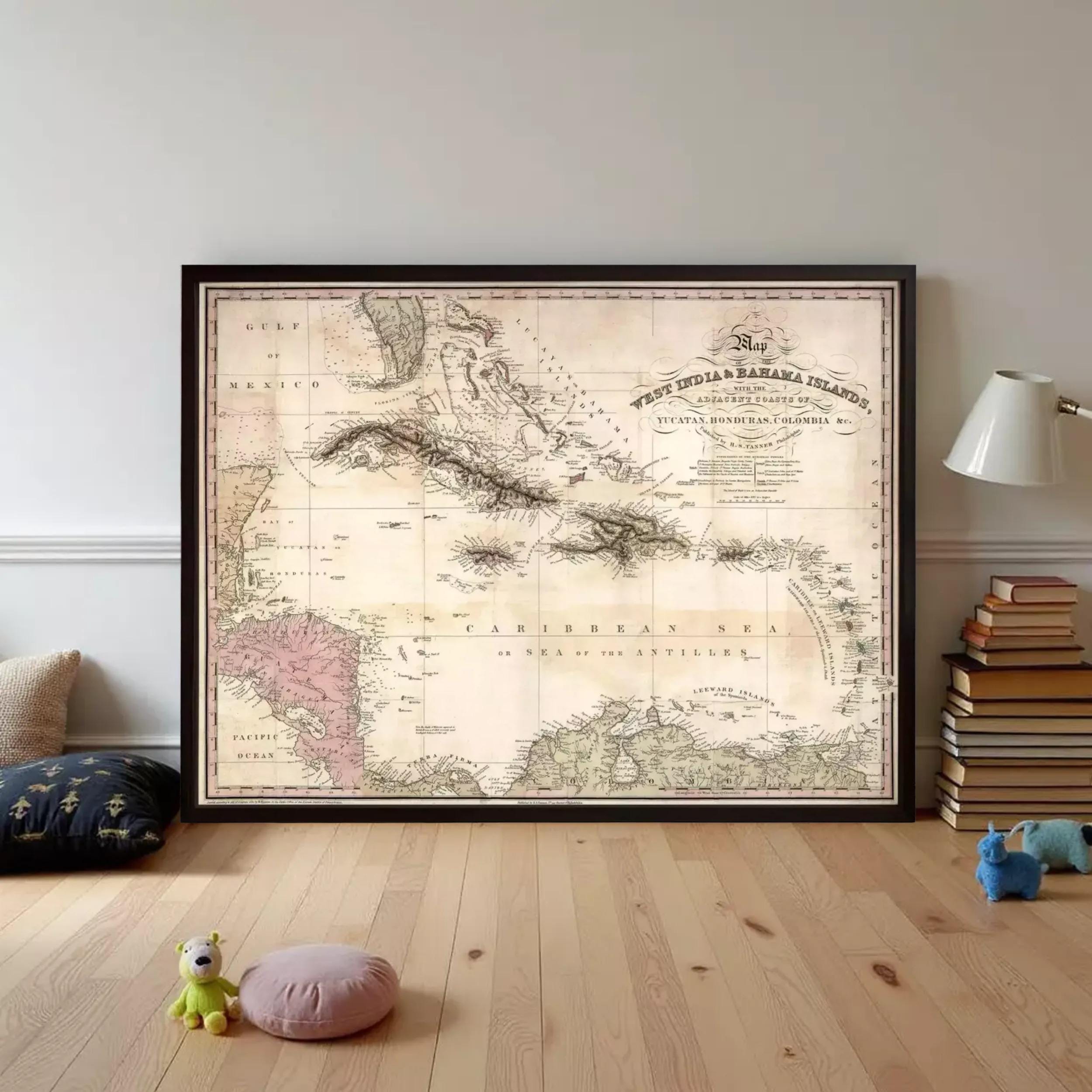 a large framed map of the Caribbean Sea, with a vintage style and a dark border. The map is displayed on a wall, surrounded by various books and toys, creating a cozy and intellectual atmosphere.