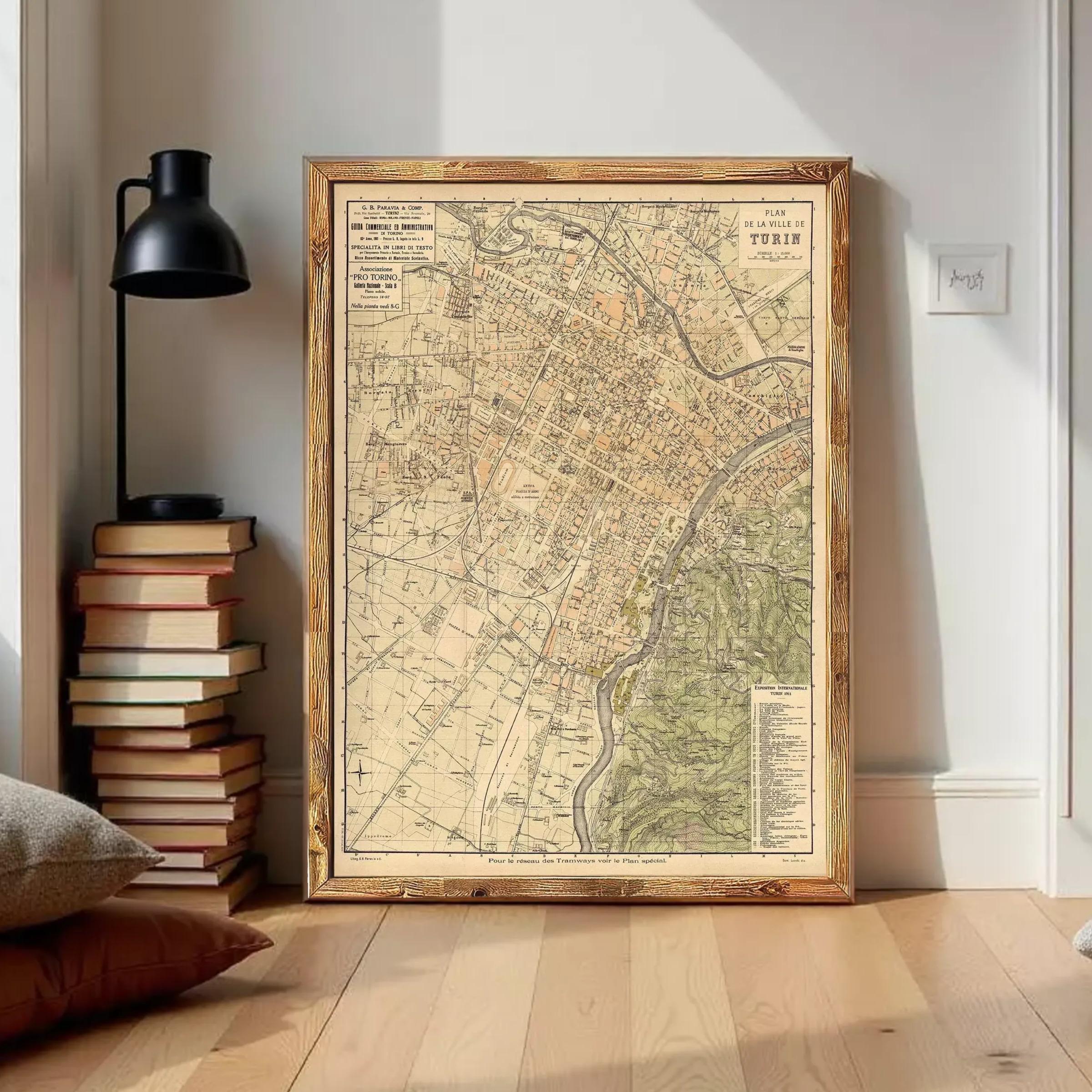 The image is a framed vintage map of a city, likely from the 19th century, displayed on a wall.