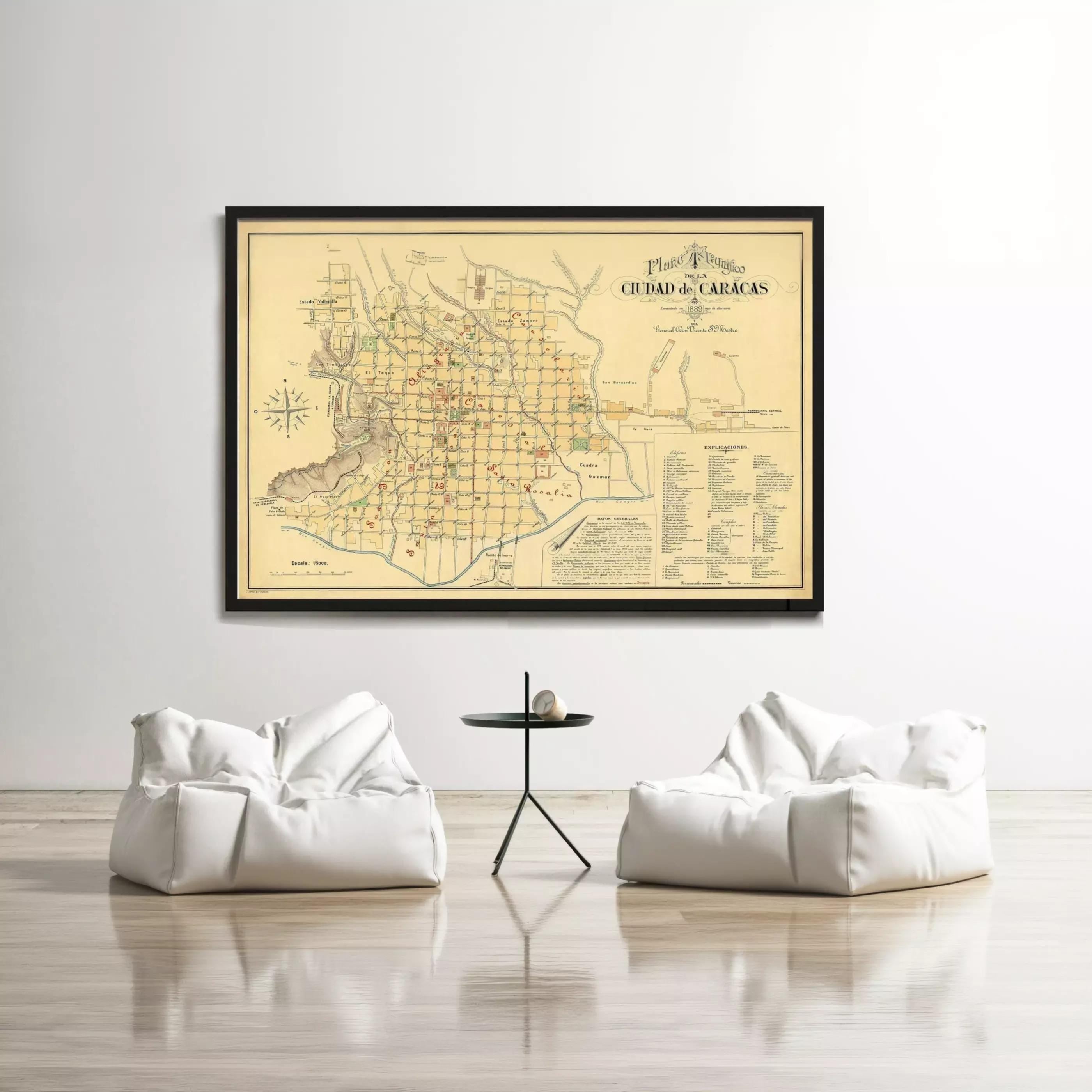 a large framed map of a city hanging on a wall, with two white bean bag chairs positioned in front of it.