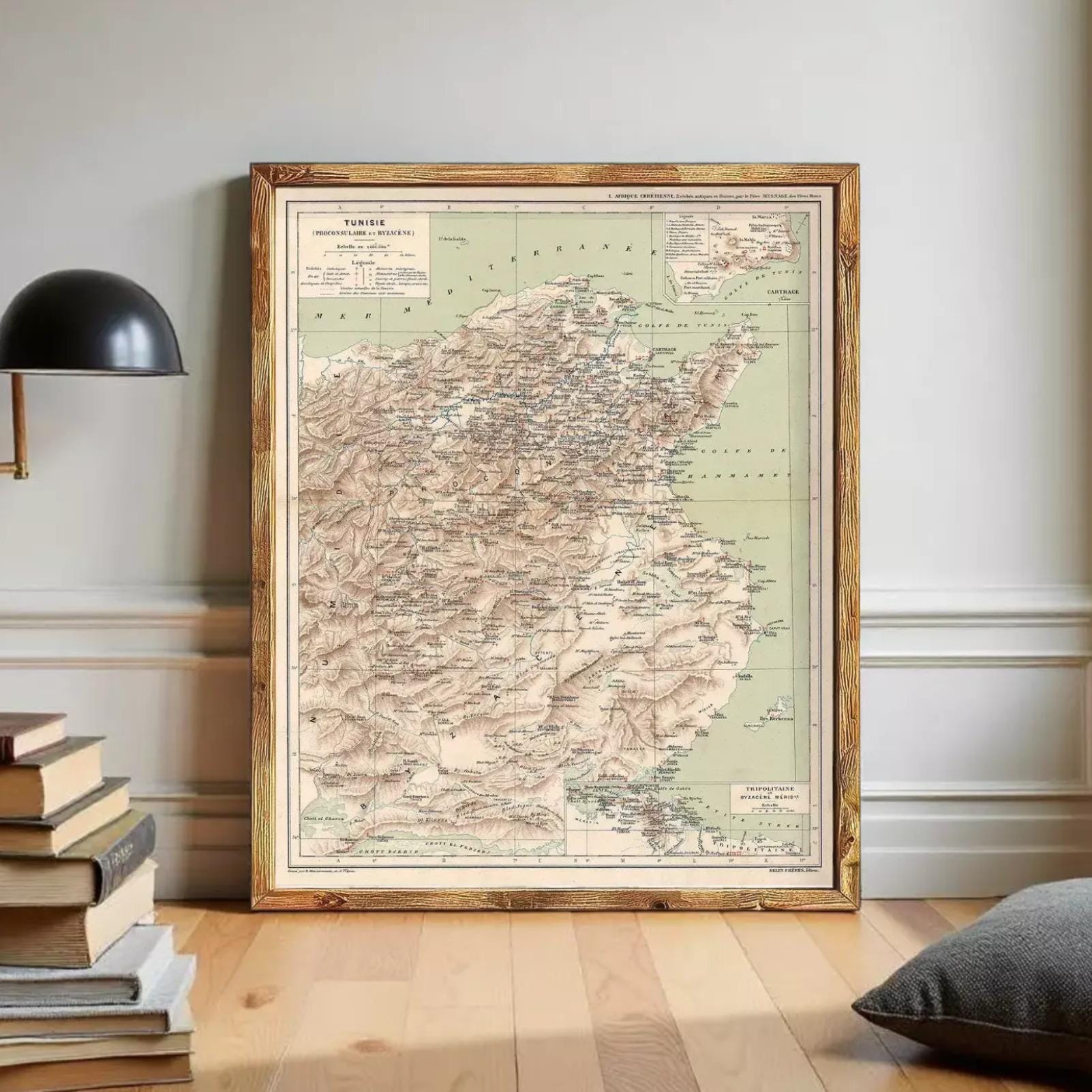 a large framed map of Turkey, with a wooden frame and a black lamp on a shelf next to it.