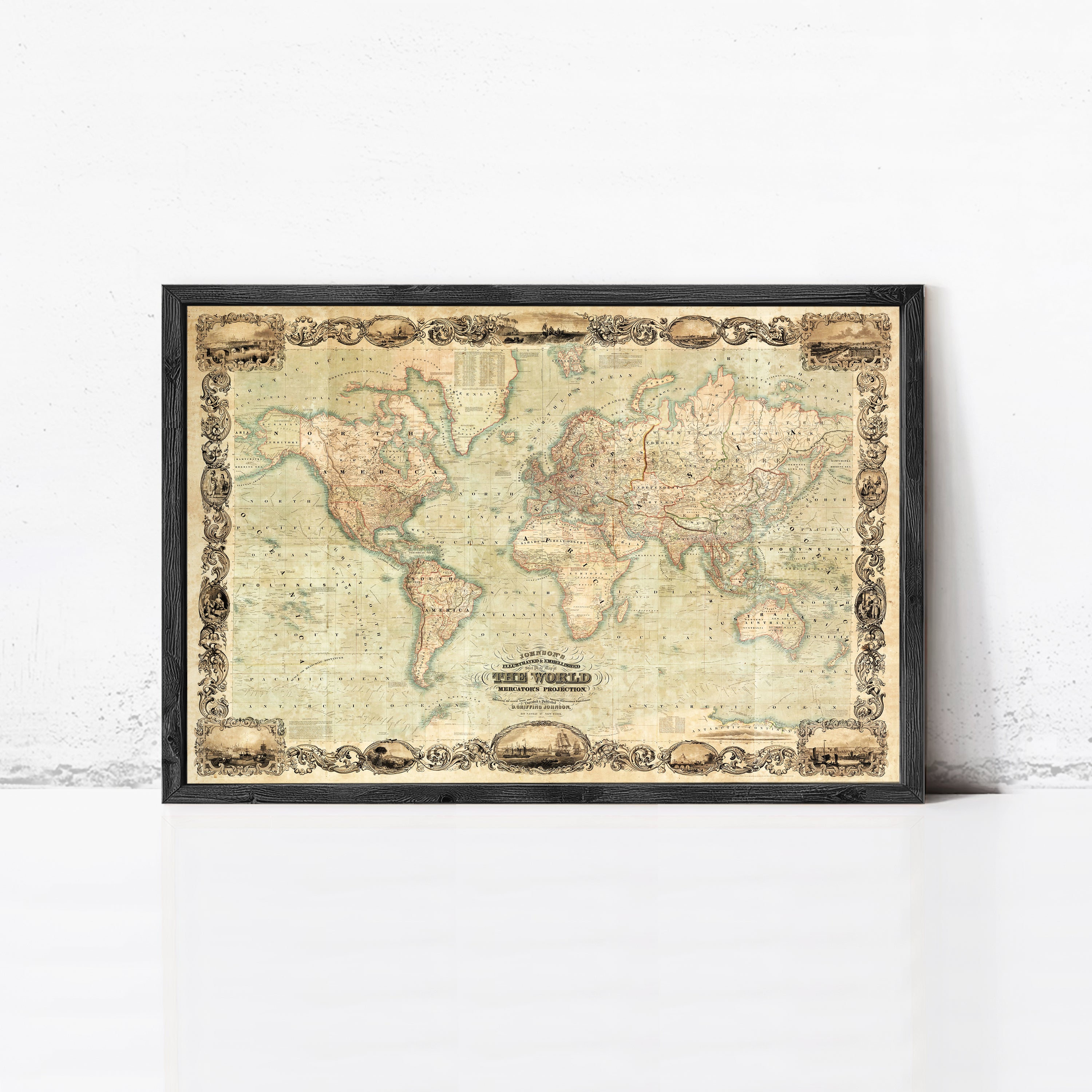 The image is a framed vintage world map with a decorative border, displayed on a white wall.