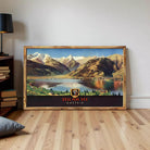 A framed vintage poster depicting a scenic mountain landscape with a lake and a town in the foreground, with the text "ZELL AM SEE AUSTRIA" prominently displayed.
