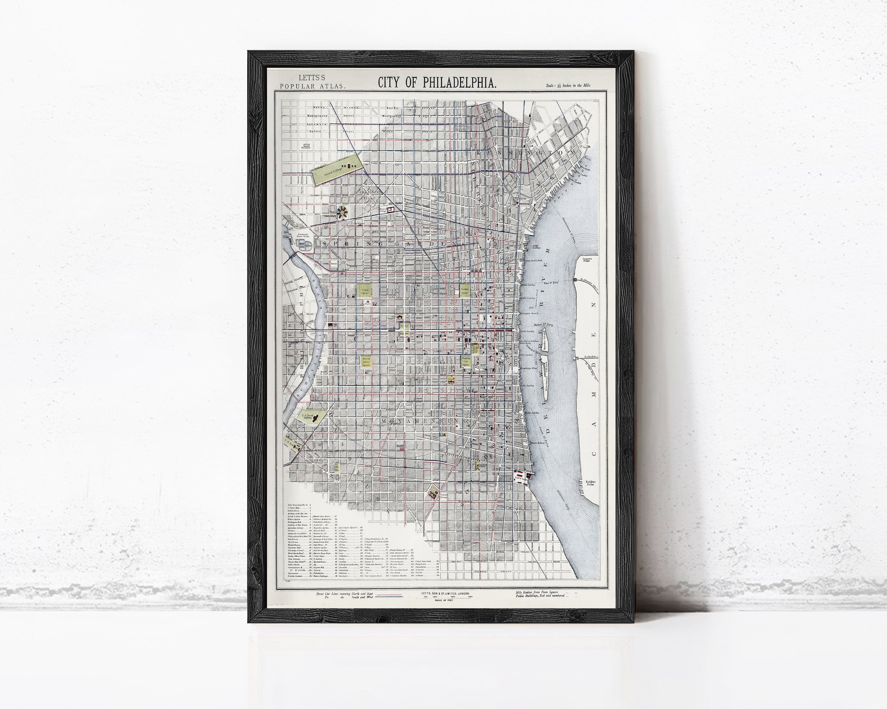 The image is a framed map of Philadelphia, Pennsylvania, depicting the city's streets, landmarks, and surrounding areas.