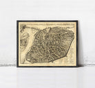 The image is a framed antique map of a city, likely from the 16th century, depicting a detailed layout of the city's streets and surrounding areas.