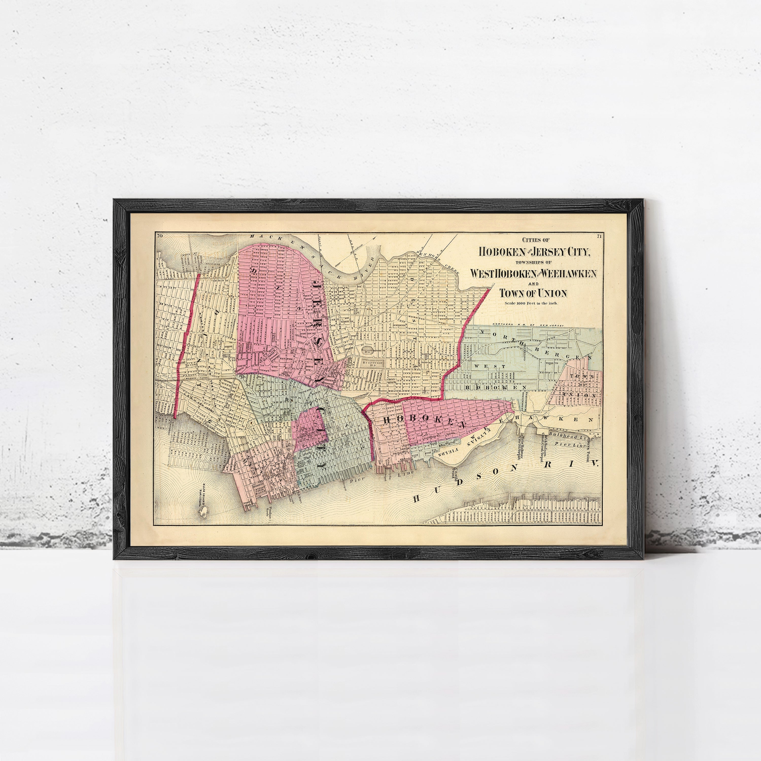 The image is a framed vintage map of Hoboken, Jersey City, New Jersey, depicting the city's layout and surrounding areas.