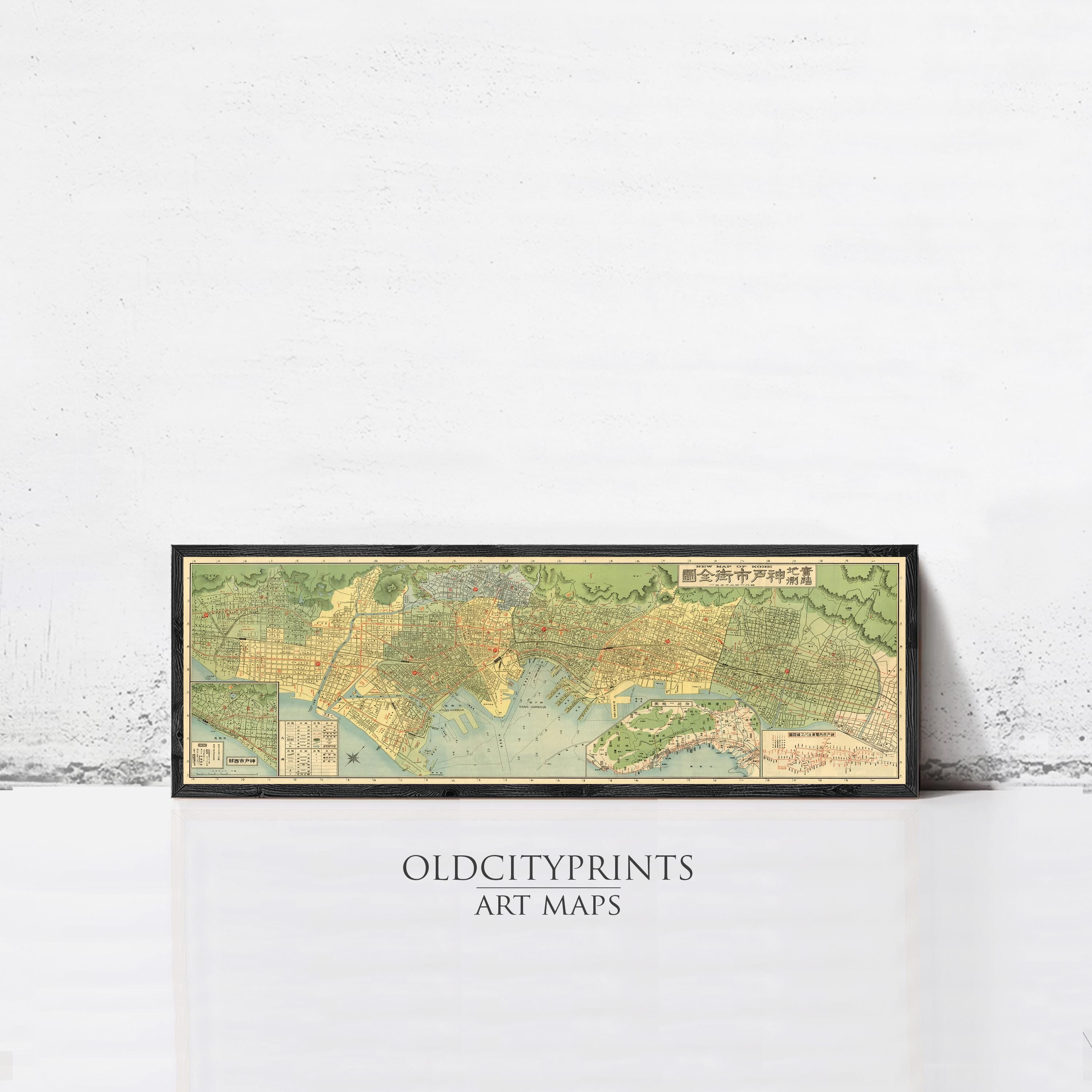 A framed vintage map of a city, likely from the past, displayed against a white wall.