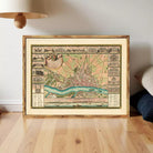 The image is a framed vintage map of a city, depicting various landmarks and buildings in a detailed and intricate manner.