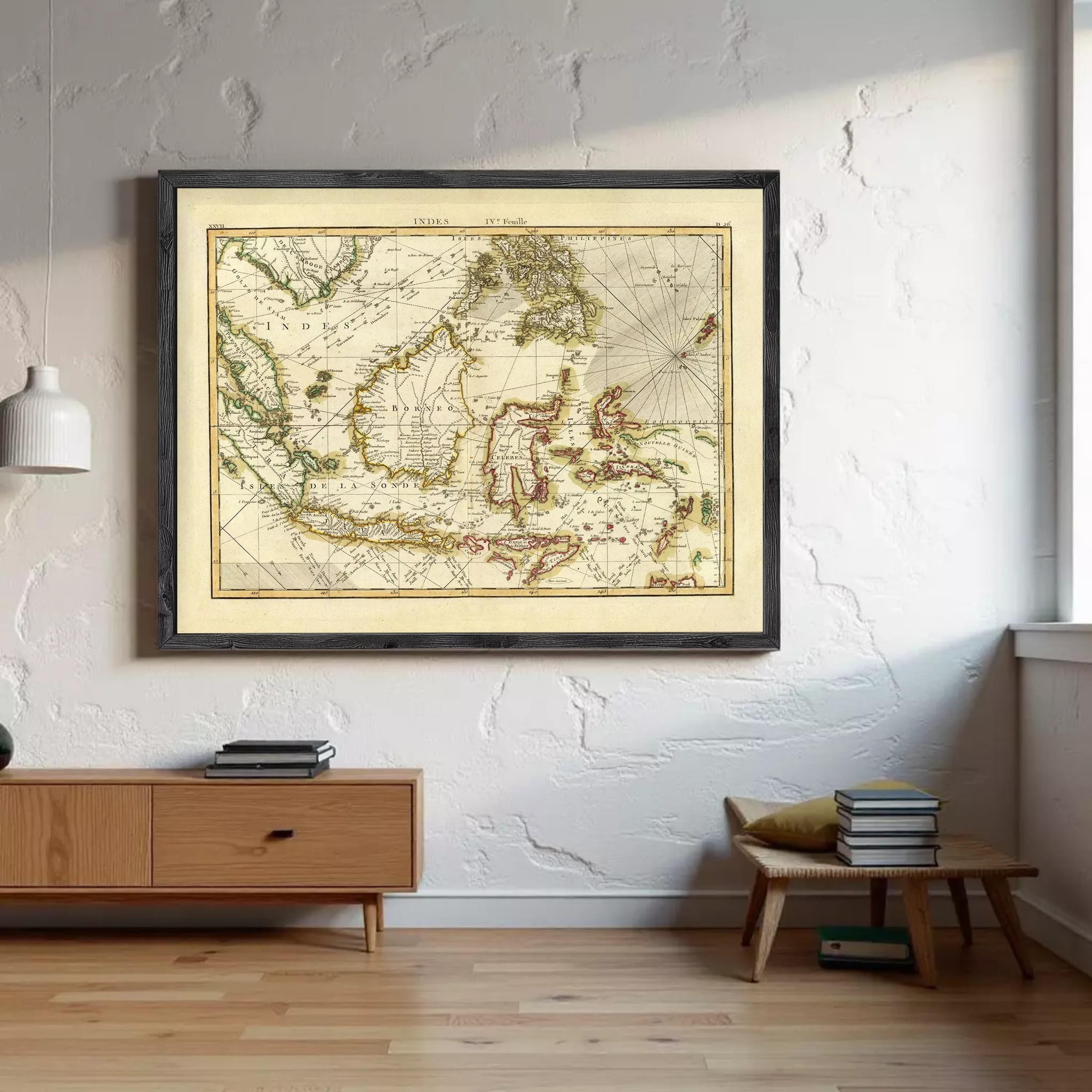 a large framed map of the world hanging on a wall, with a wooden dresser and a stack of books on a table below it.
