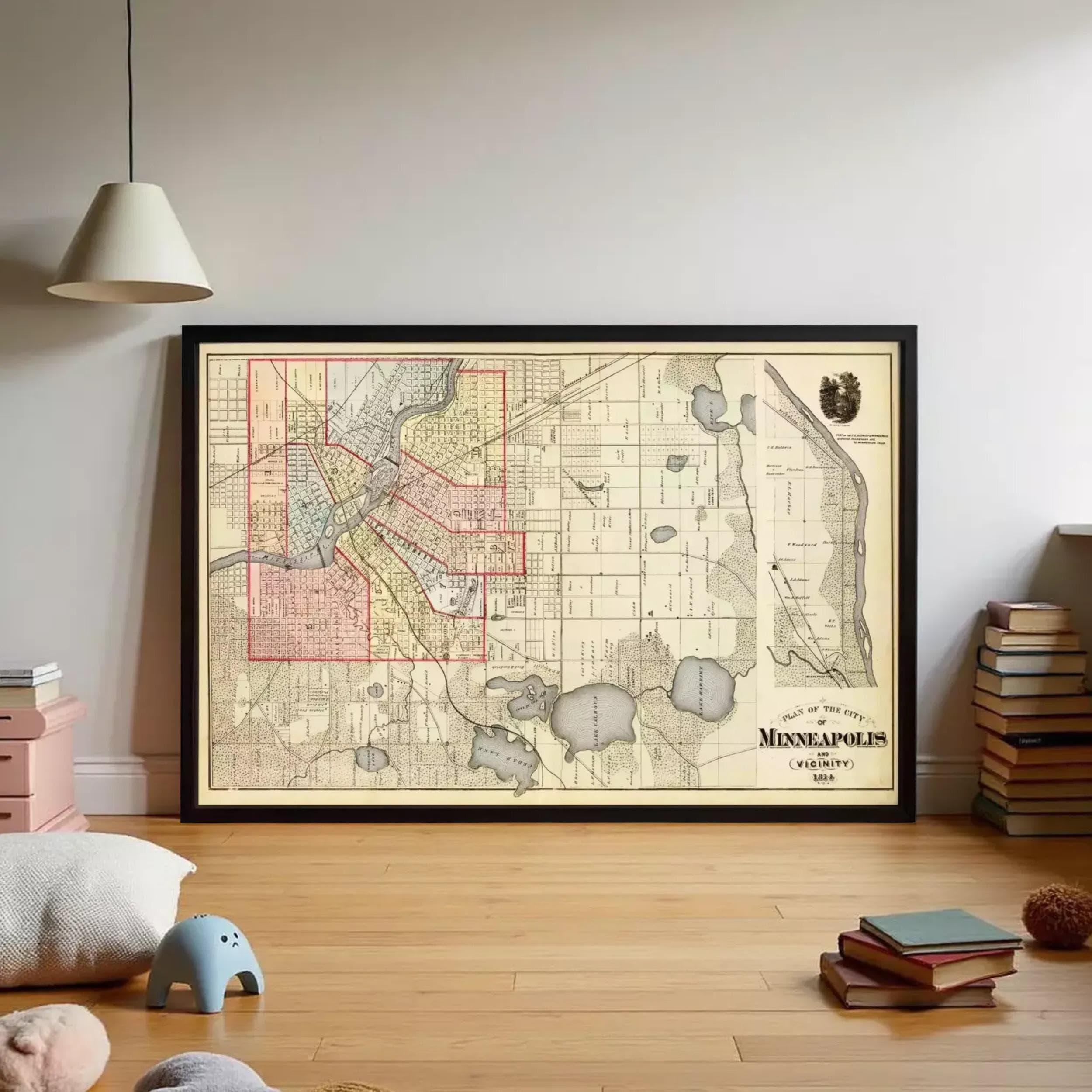 a large framed map of Minneapolis, Minnesota, with a vintage style and a black frame. The map is displayed on a wall in a room with a wooden floor.