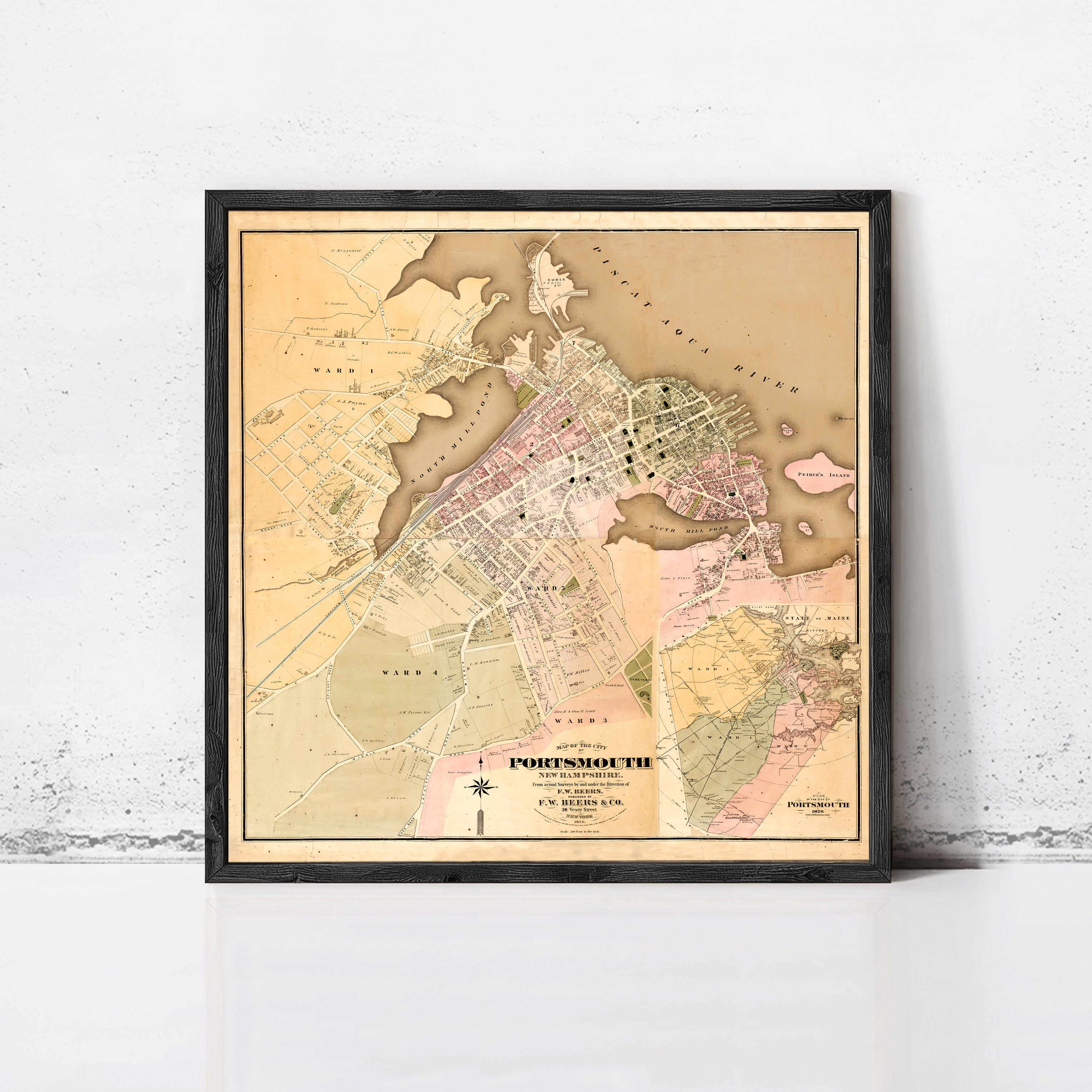 The image is a framed vintage map of the town of Portland, Oregon, showing the layout of the streets, landmarks, and surrounding areas.
