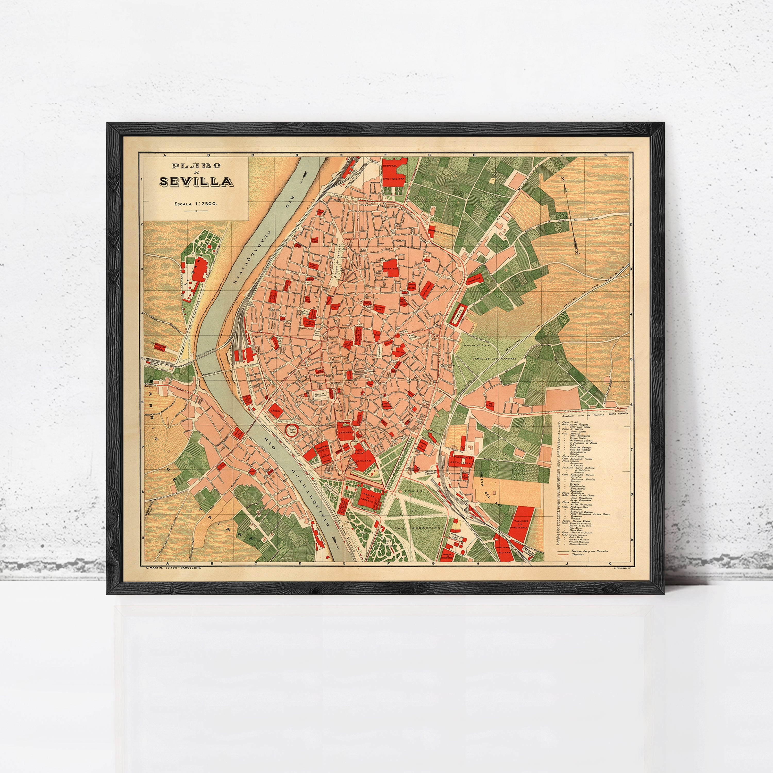 The image is a framed vintage map of the city of Seville, Spain, depicting the city's layout and surrounding areas.