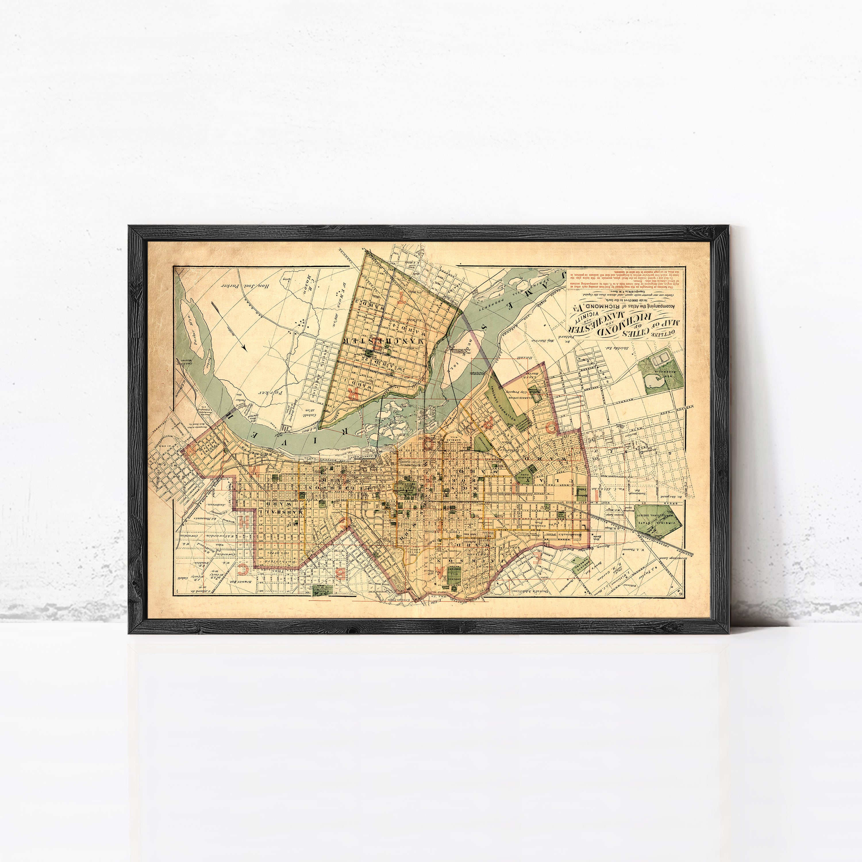 The image is a framed vintage map of a city, depicting streets, landmarks, and other geographical features.