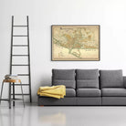a gray sofa with a yellow blanket draped over it, and a framed map of the Philippines hanging on the wall above the sofa.