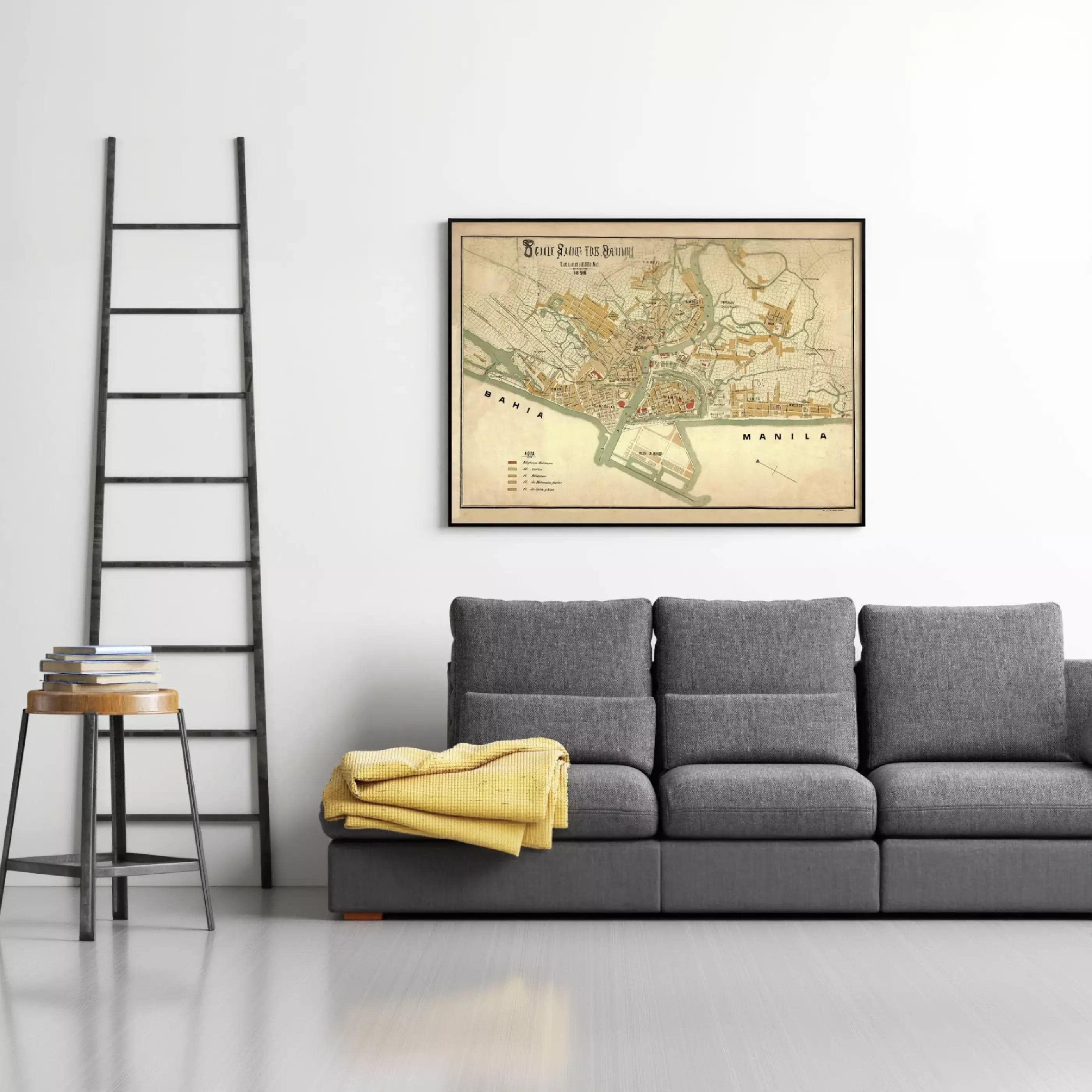 a gray sofa with a yellow blanket draped over it, and a framed map of the Philippines hanging on the wall above the sofa.