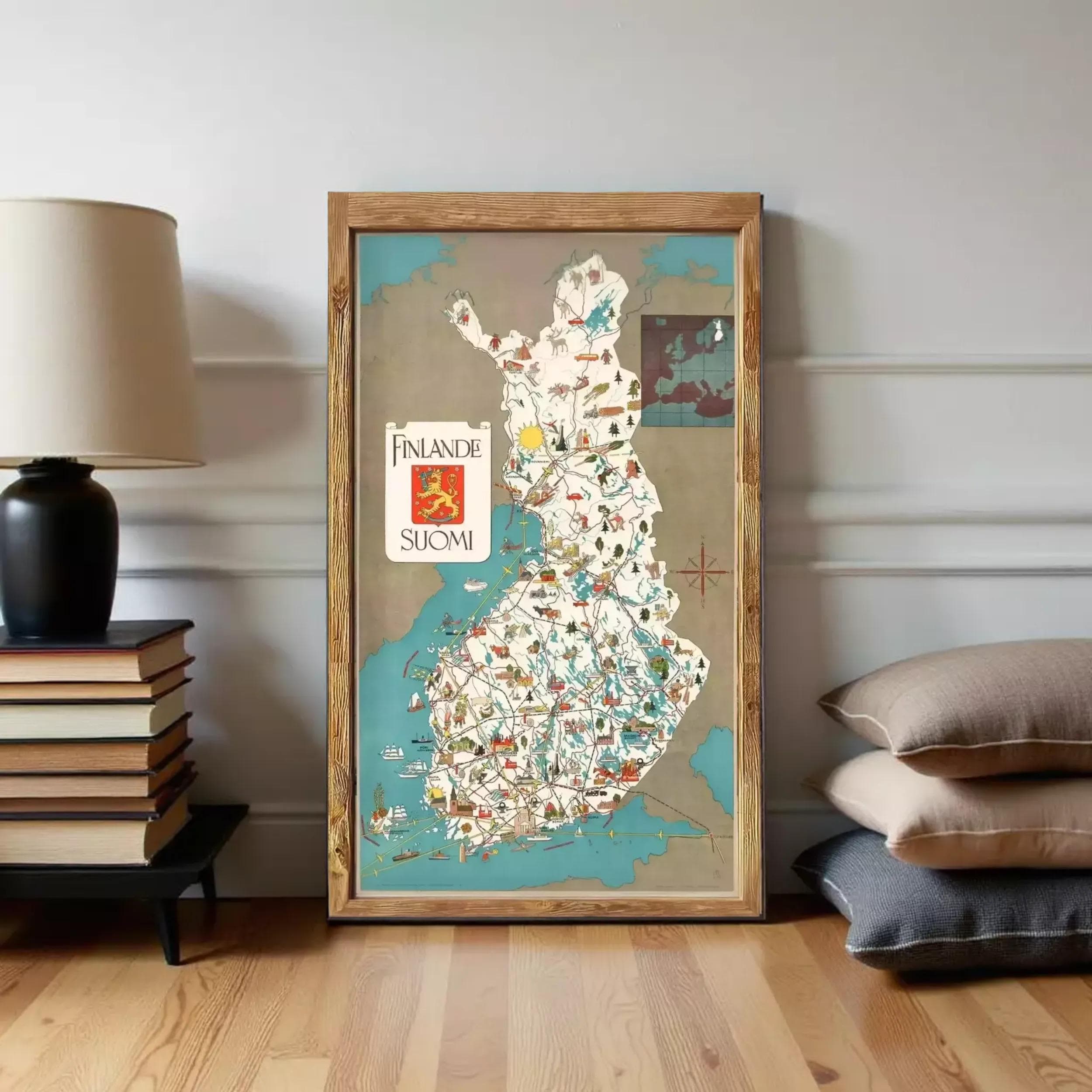A framed map of Finland is displayed on a wall, with a stack of books and a lamp to the left.