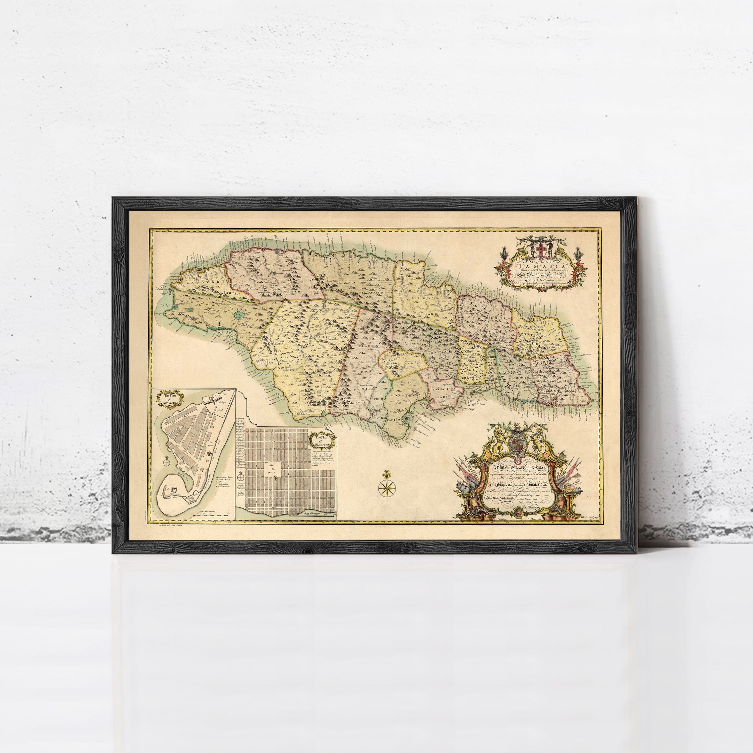 The image is a framed vintage map of Jamaica, featuring detailed geographical information and a decorative border.