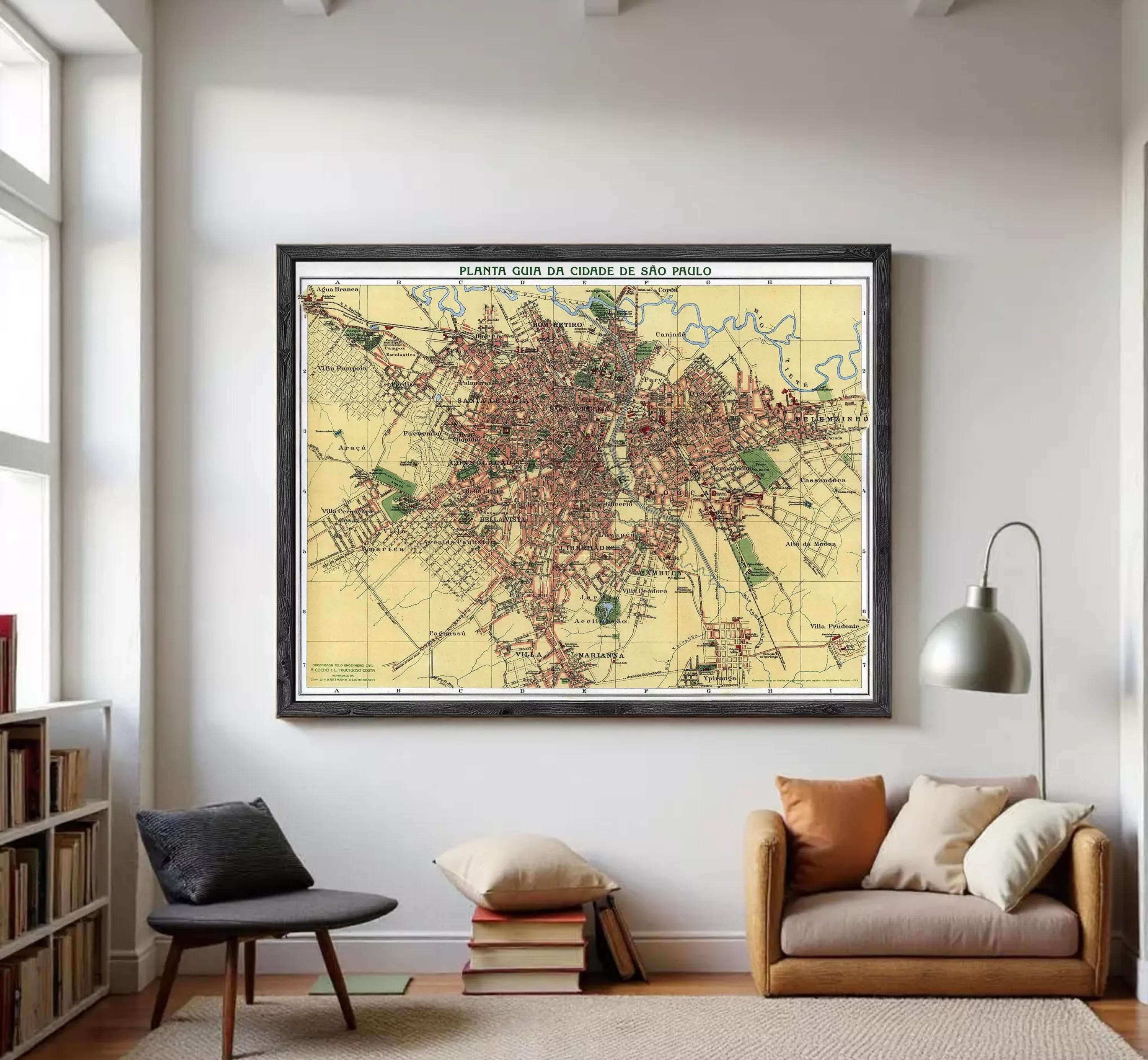 The image is a framed map of a city, likely from the early 20th century, depicting a detailed layout of the city's streets, landmarks, and other features.