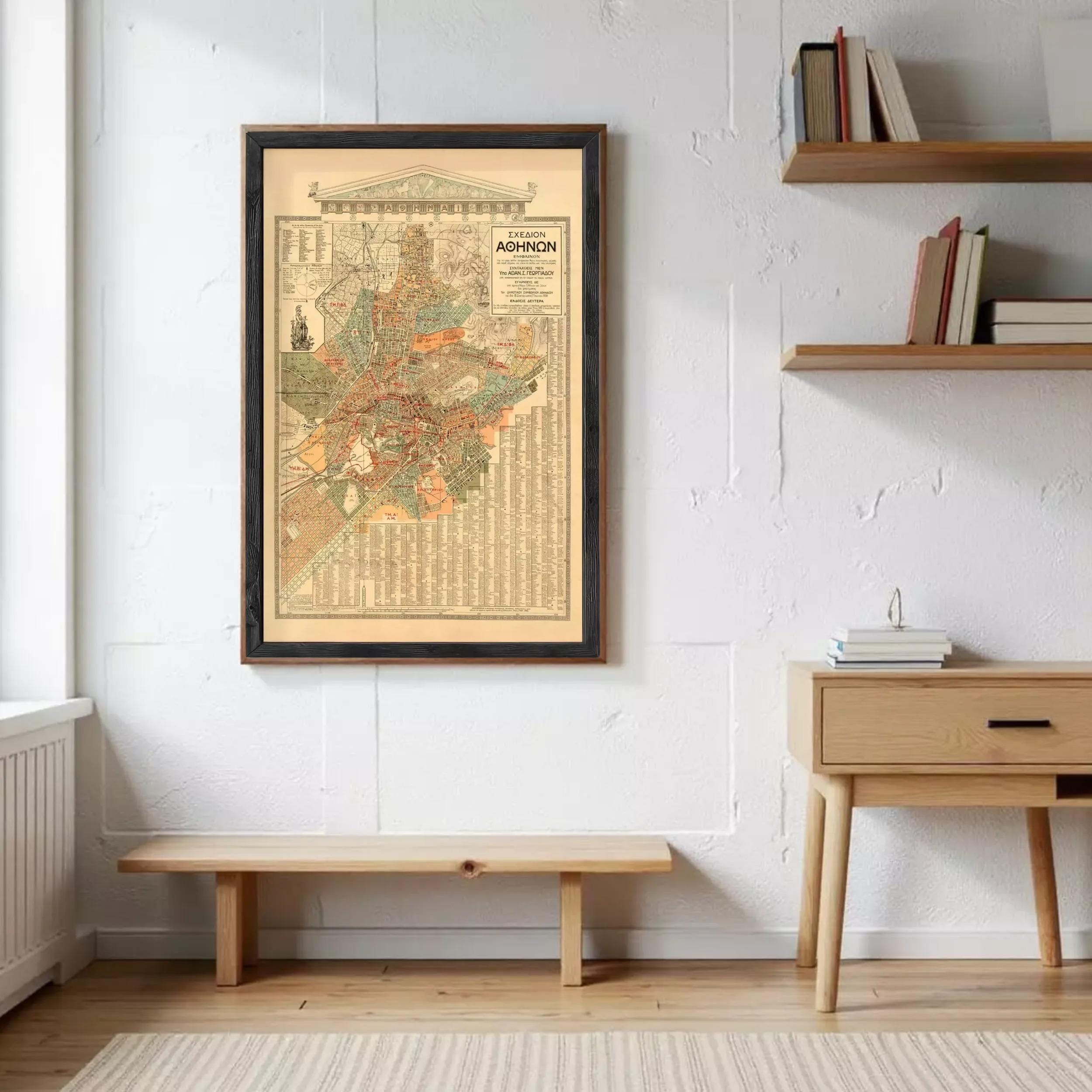 a framed map of the city of Philadelphia hanging on a white wall, with a wooden bench and a wooden table below it.