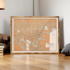 a framed map of Edmonton, Canada, with a wooden frame and a light brown color. The map appears to be a vintage or historical representation of the city.