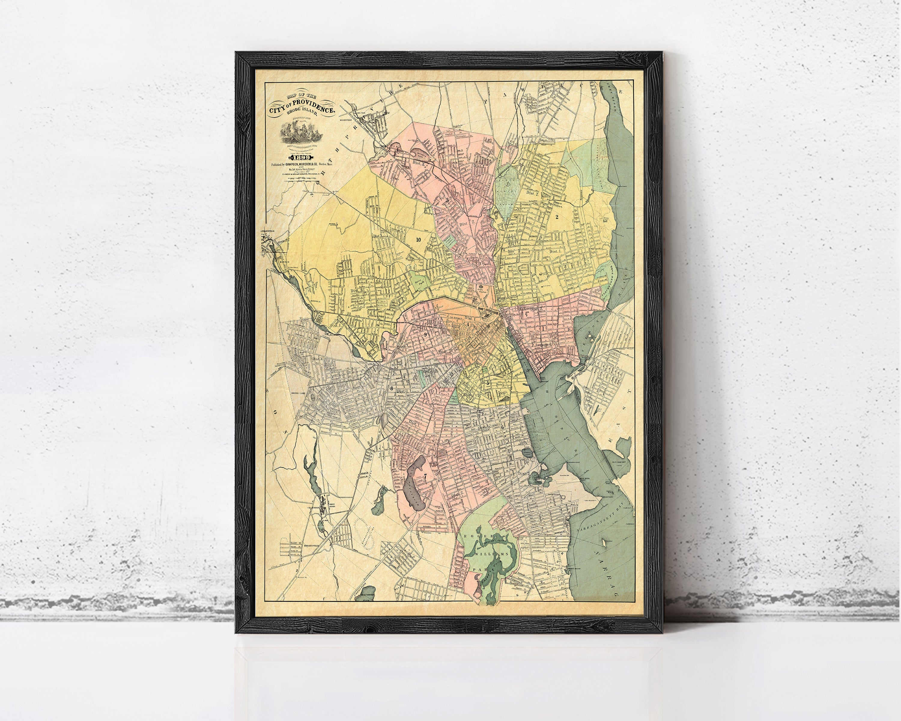 The image is a framed vintage map of a city, likely from the 19th century, depicting the layout and geographical features of the area.