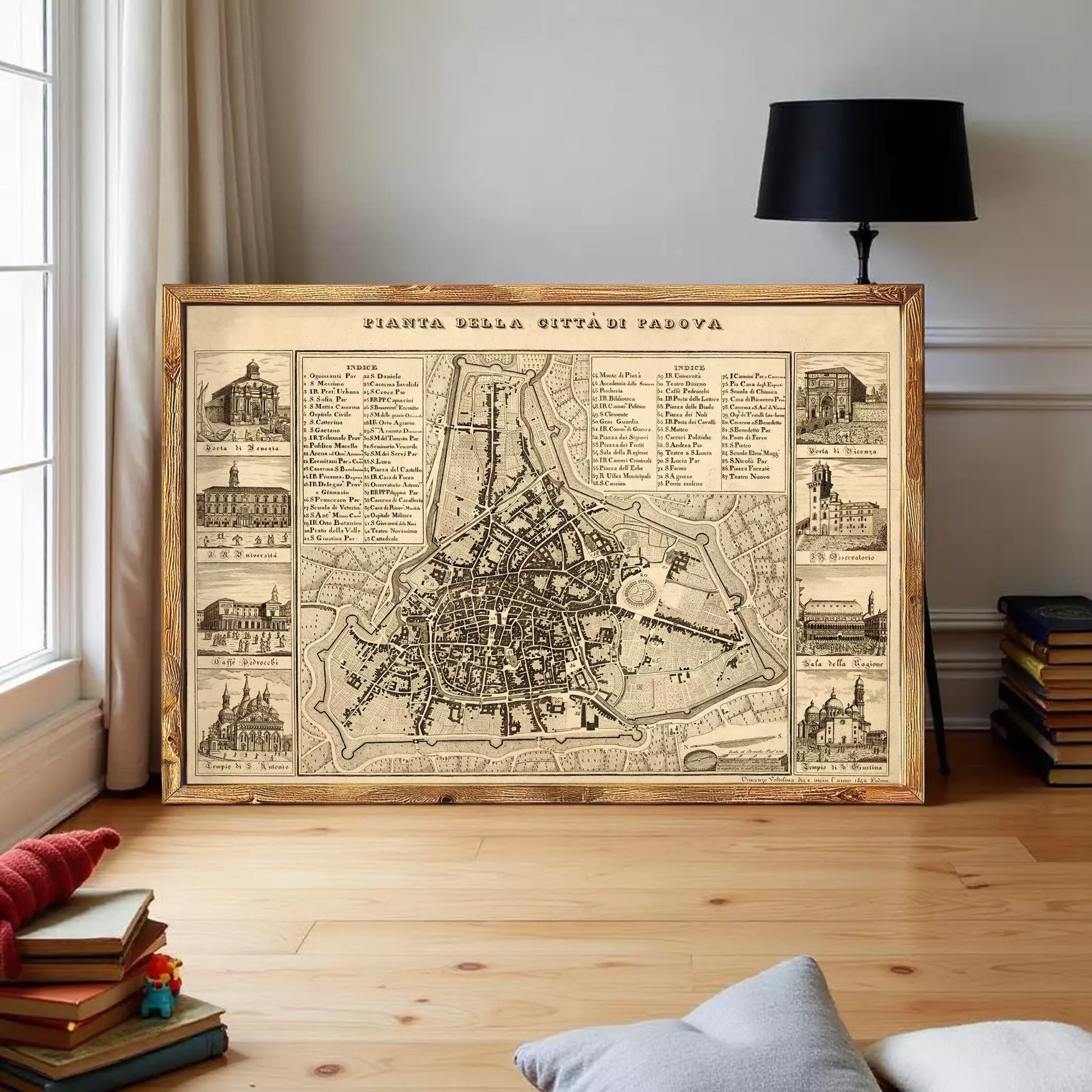 a large framed map of a city, with various buildings and landmarks depicted on it. The map is displayed on a wooden floor in a room with a window and a lamp.