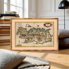 The image is a framed vintage map of Iceland, featuring detailed illustrations and labels.