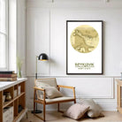 A cozy living room with a wooden chair, a floor lamp, and a framed map of Iceland on the wall.