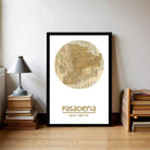A framed vintage map of Pasadena, California, with the text "Pasadena 34° 9' 11.7 W" printed on it.