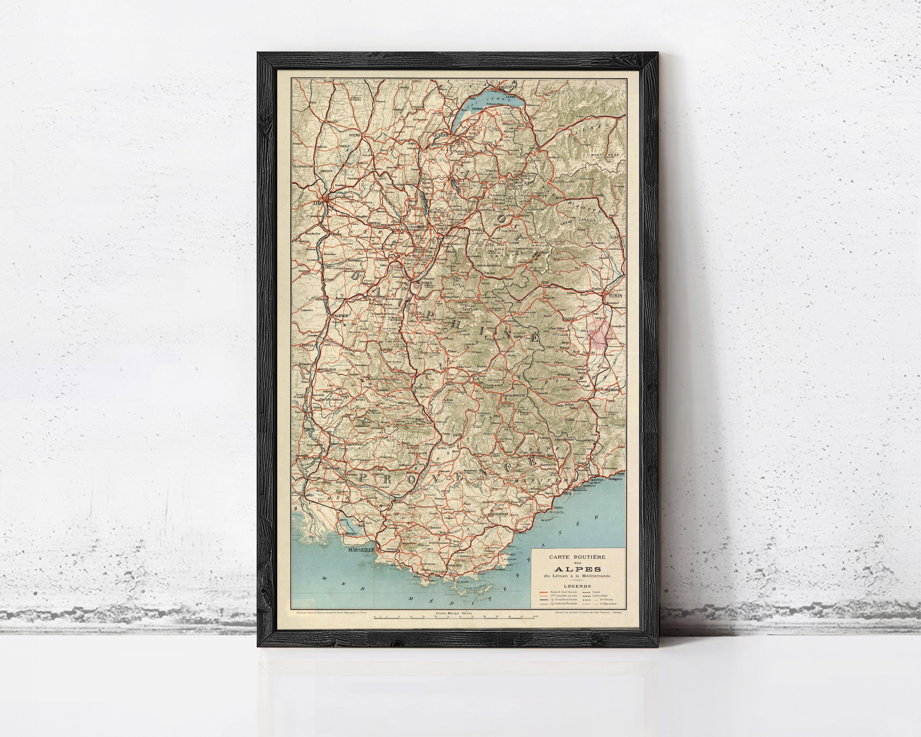 The image is a framed vintage map of the Alpes region, depicting the various mountain ranges and roads in the area.