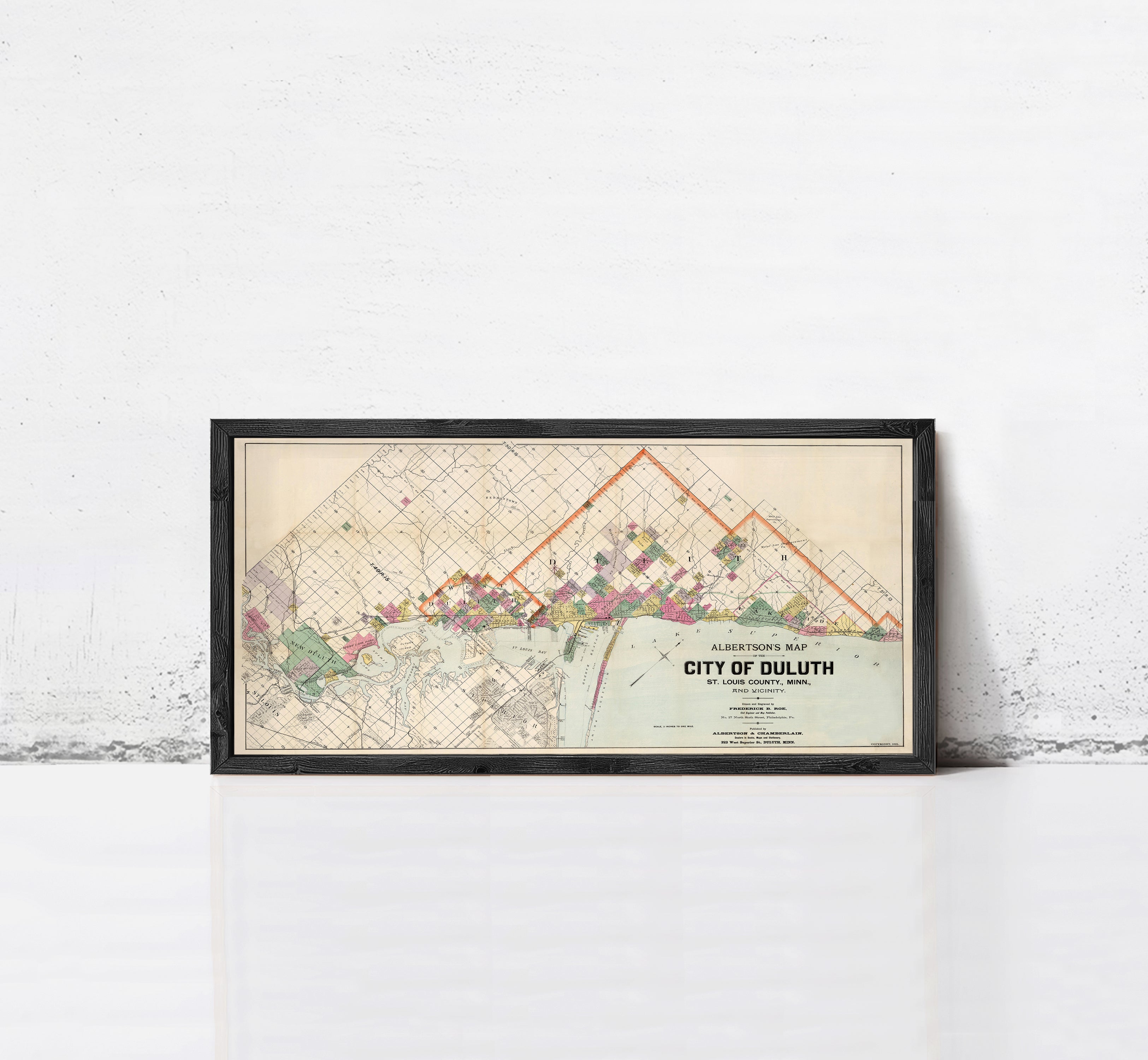 A framed map of the City of Duluth, Minnesota, depicting the city's layout and surrounding areas.