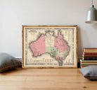 The image is a framed vintage map of Australia, depicting the country in a detailed and intricate manner.
