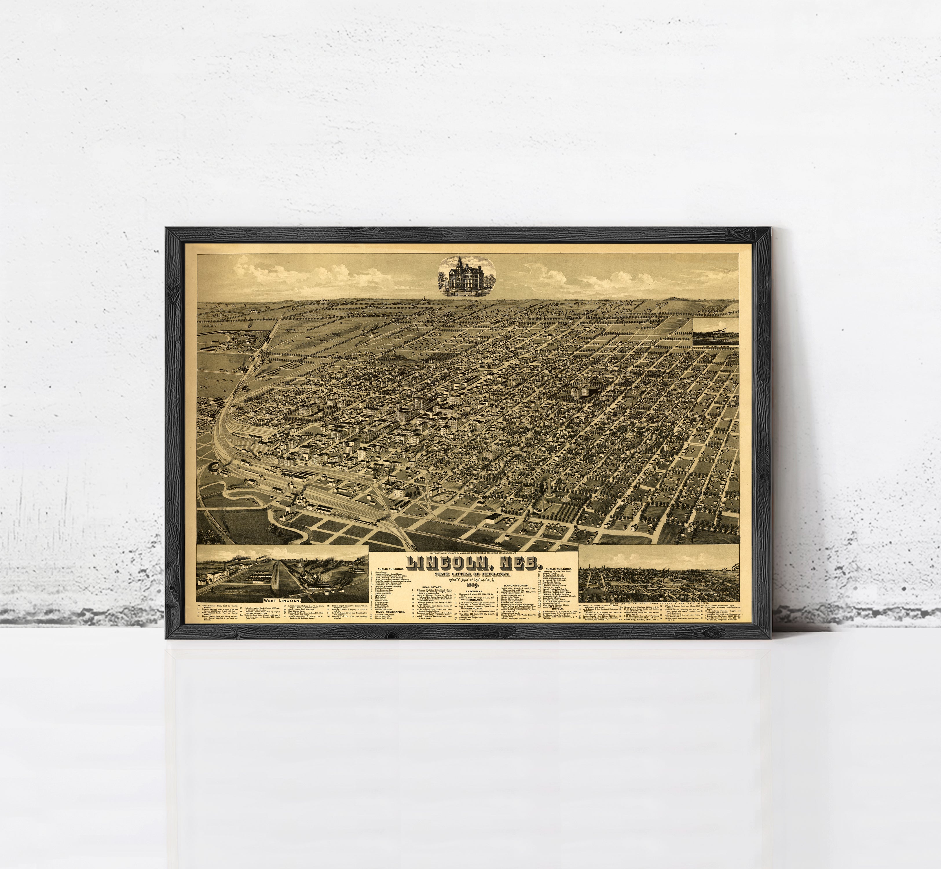 The image is a framed vintage map of a city, depicting a detailed aerial view of the urban landscape.