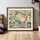 The image is a framed vintage map of a city, depicting a detailed layout of the city's streets, buildings, and other landmarks.