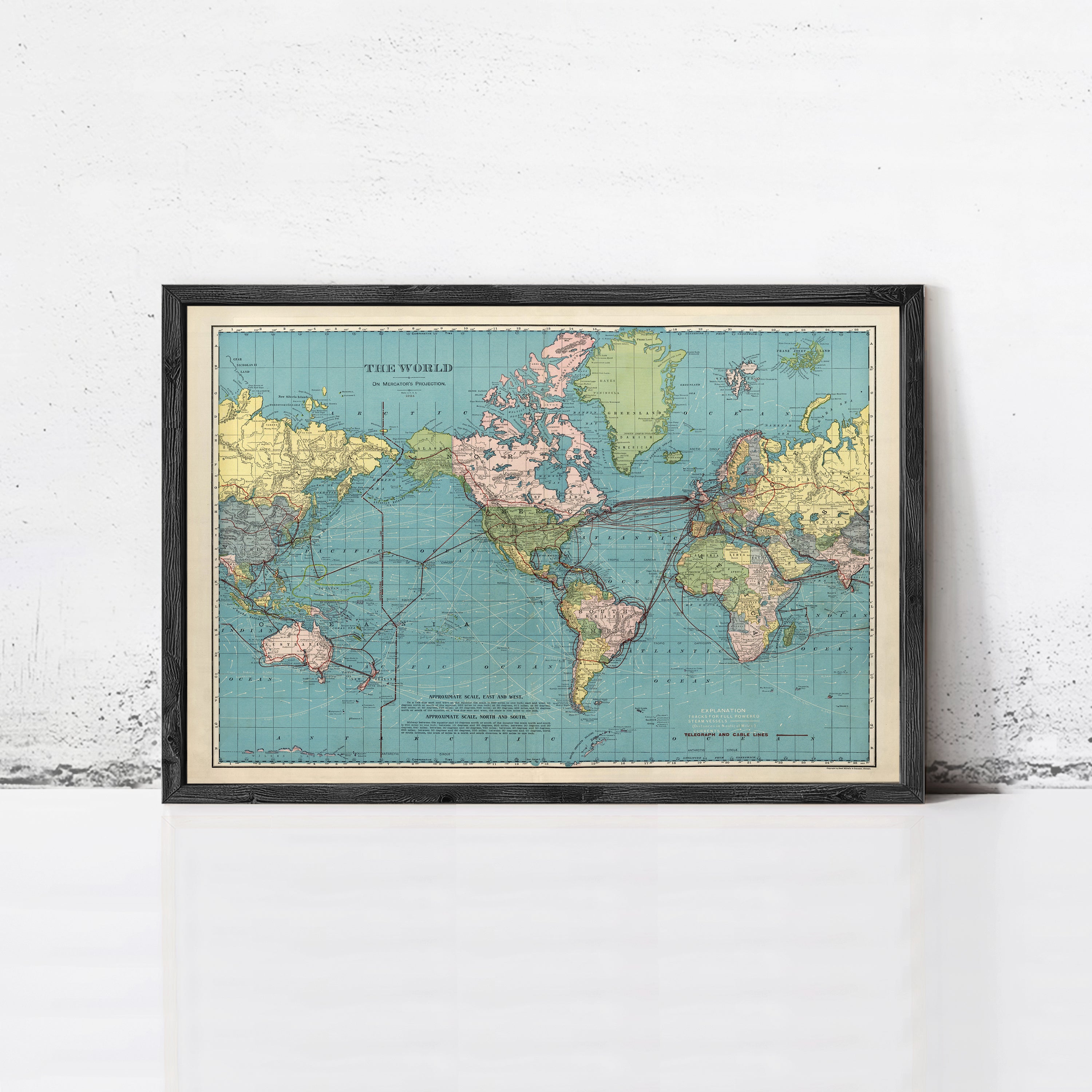 The image is a framed vintage map of the world, depicting the continents and oceans in a colorful and detailed manner.