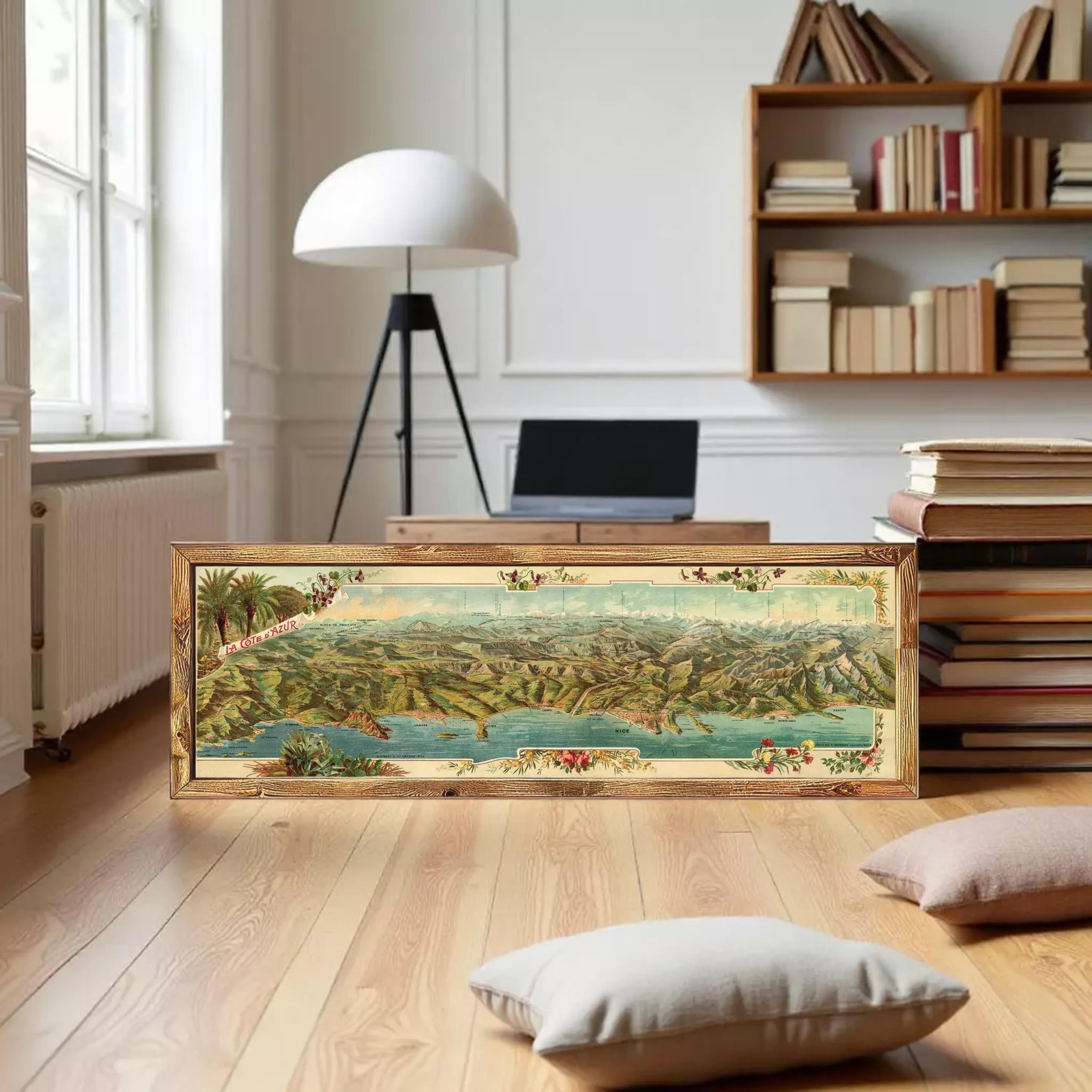 A framed painting depicting a scenic landscape with mountains, water, and vegetation.