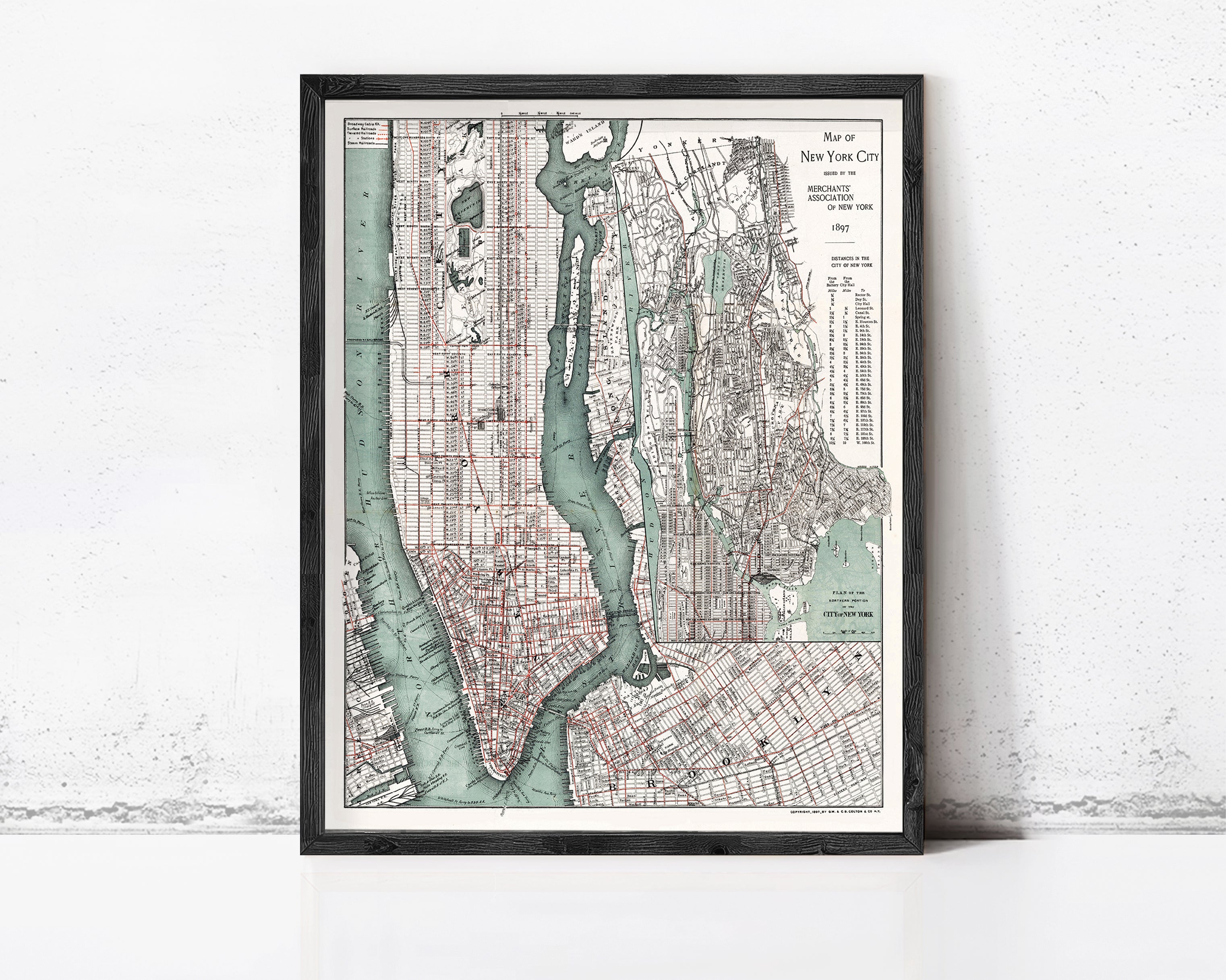 The image is a framed vintage map of New York City, depicting the city's streets, waterways, and surrounding areas.