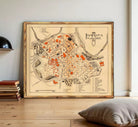 The image is a framed map of the city of Pamplona, Spain, depicting the layout and various landmarks within the city.