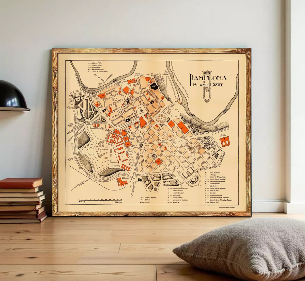 The image is a framed map of the city of Pamplona, Spain, depicting the layout and various landmarks within the city.